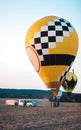 A hot air balloon way up high in the sky having a flight into the sunset.