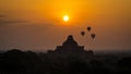 Hot air balloons in Bagan flying above ancient pagoda in Myanmar