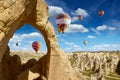 Hot air balloons flies in blue sky in Kapadokya, Turkey