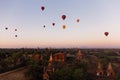 Hot air balloons floating around Burmese pagoda heritage site during sunrise landscape. Royalty Free Stock Photo