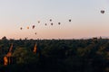 Hot air balloons floating around Burmese pagoda heritage site during sunrise landscape. Royalty Free Stock Photo