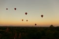 Hot air balloons floating around Burmese pagoda heritage site during sunrise landscape. Royalty Free Stock Photo