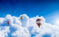 Hot air balloons fly in blue sky with white clouds and moon, sunny weather Royalty Free Stock Photo