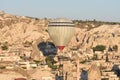 Hot air balloons fly in clear morning sky near Goreme, Kapadokya