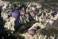 Hot air balloons fly over the spectacular Goreme landscape in the Cappadocia region of Turkey.