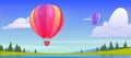 Hot air balloons flying above pond, field, rocks Royalty Free Stock Photo