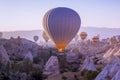 Hot air balloons flying in beautiful Cappadocia hilly landscape, amazing tourism attraction in Goreme, Anatolia, Turkey, morning Royalty Free Stock Photo