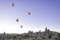 hot air balloons flying over the fairy chimneys, at the Goreme airfield at dawn, Cappadocia, Red Valley, Turkey, Goreme National Royalty Free Stock Photo