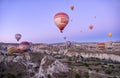 hot air balloons flying over the fairy chimneys, at the Goreme airfield at dawn, Cappadocia, Red Valley, Turkey, Goreme National Royalty Free Stock Photo