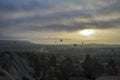 Hot air balloons flying over mountains landscape and the valley at Cappadocia in the sunrise sky at foggy morning Royalty Free Stock Photo