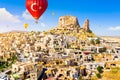 Hot air balloons flying over Uchisar Castle. Cappadocia. Nevsehir Province. Turkey Royalty Free Stock Photo