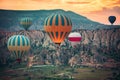 Hot air balloons flying over the valley at Cappadocia.