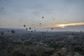 Hot air balloons flying over the valley and rock formations with fairy chimneys near Goreme, Cappadocia, Turkey Royalty Free Stock Photo