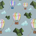 Hot air balloons flying in sky covered with clouds over the green mountains on blue background. Seamless pattern. Movement, travel Royalty Free Stock Photo