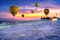 Hot air balloons and Natural travertine pools at sunset in Pamukkale, Turkey