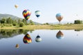 Hot Air Balloons Over a Lake with Reflections in Colorado Royalty Free Stock Photo