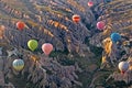 Hot air balloons over mountain landscape in Cappadocia, Turkey