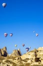 Hot air balloons overhanging the ancient dwellings of the bewitching Cappadocia, Turkey