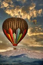 Hot Air Balloons before Pikes Peak Mountain under a cloudy morning sky