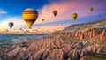 Hot air balloons and Red valley at sunset in Goreme, Cappadocia in Turkey. Royalty Free Stock Photo