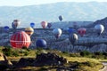 Hot air balloons rise in a wave from Rose Valley as the sun rises near Goreme in the Cappadocia region of Turkey.