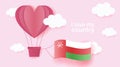 Hot air balloons in shape of heart flying in clouds with national flag of Oman. Paper art and cut, origami style with love to Oman Royalty Free Stock Photo