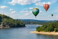 Hot air balloons in the sky over Vltava river near Orlik castle. Czechia Royalty Free Stock Photo