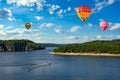 Hot air balloons in the sky over Vltava river near Orlik castle. Czechia Royalty Free Stock Photo