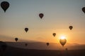 Hot air balloons in the sky during sunrise. Flying over the valley at Cappadocia, Anatolia, Turkey. Volcanic mountains in Goreme n Royalty Free Stock Photo