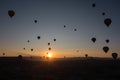 Hot air balloons in the sky during sunrise. Flying over the valley at Cappadocia, Anatolia, Turkey. Volcanic mountains in Goreme Royalty Free Stock Photo