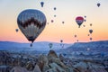 Hot air balloons between the texture of rocks in cappadoccia at sunrise Royalty Free Stock Photo