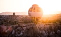 Hot air balloons between the texture of rocks in cappadoccia at sunrise