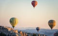 Hot air balloons between the texture of rocks in cappadoccia at sunrise