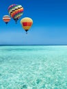 Hot air balloons travel over the sea Royalty Free Stock Photo