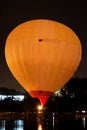 Hot air baloon starting to fly in the evening sky Royalty Free Stock Photo