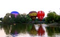 Hot air baloons startung to fly in the evening sky Royalty Free Stock Photo