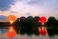 Hot air baloons startung to fly in the evening sky Royalty Free Stock Photo