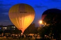 Hot air baloons startung to fly in the evening sky