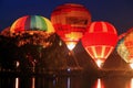 Hot air baloons startung to fly in the evening sky Royalty Free Stock Photo
