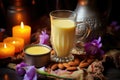 hot almond milk with saffron beside diwali lamps