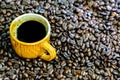 Hot americano, Black coffee in yellow cup with coffee beans.