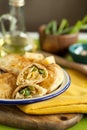 Hot appetizer for family dinner.baked puff pastry pies stuffed with chicken, cheese,pepper on wooden board and green background