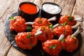 Hot appetizer Lollipops fried red chicken wings served with sauces close-up on a slate board. horizontal Royalty Free Stock Photo