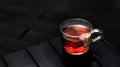 Hot Apple Cinnamon Tea with tea bag served in a cup isolated on dark background side view Royalty Free Stock Photo