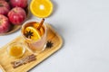 Hot apple honey cider on light background. Traditional Christmas or New Year warming spicy beverage with cinnamon, star