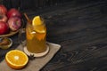 Hot apple honey punch on dark wood background. Traditional fall or winter warming spicy beverage with cinnamon, star