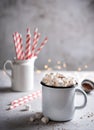 Hot aroma chocolate with marshmallows and a red paper tube on a gray table. Christmas mood