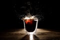 Hot and aromatic coffee spilling from transparent glass cup Royalty Free Stock Photo