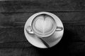Hot art Latte Coffee in a cup on wooden table black and white to Royalty Free Stock Photo