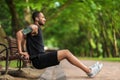 Hot athletic black man exercising in the park, side view Royalty Free Stock Photo